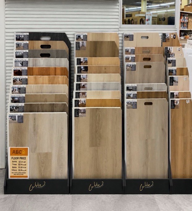 Laminate and vinyl plank flooring samples on display at 123 Building